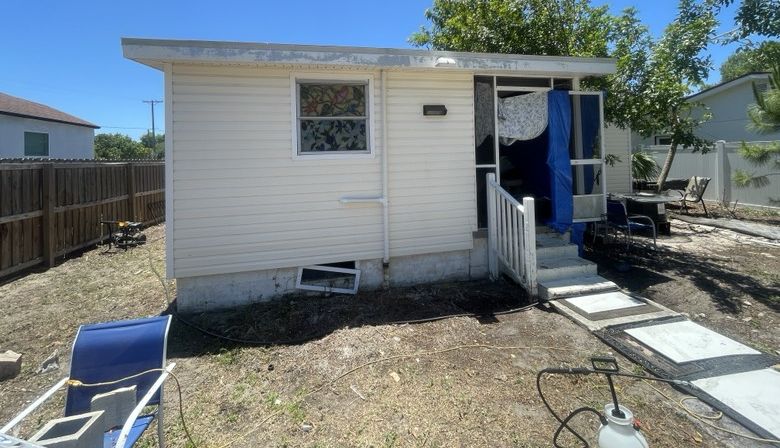 The same exterior after a CC Power Clean soft wash — clean white siding